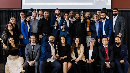 Award-winning Bravo agents holding CENTURY 21 trophies